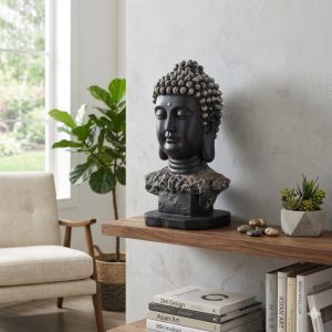 A serene Buddha head sculpture in matte black resin with silver-tipped curls, mounted on a rustic stone-textured base, isolated on white.