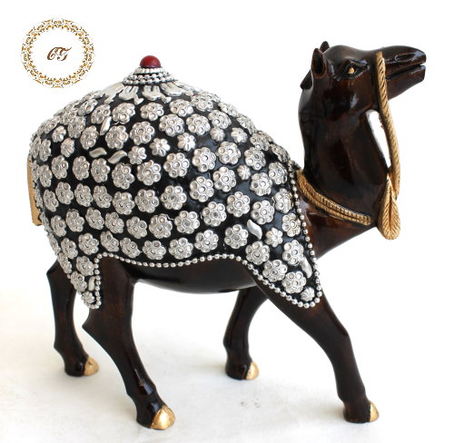 Camel Figurine_CGWCS0001 Handcrafted dark wood camel statue with silver floral metal embossing on a luxury marble table.